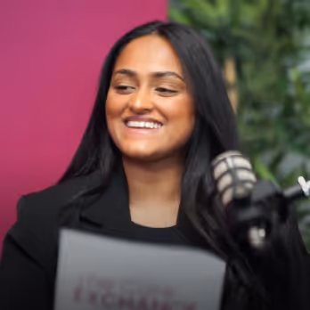 Podcast guest discussing aged care at a microphone.